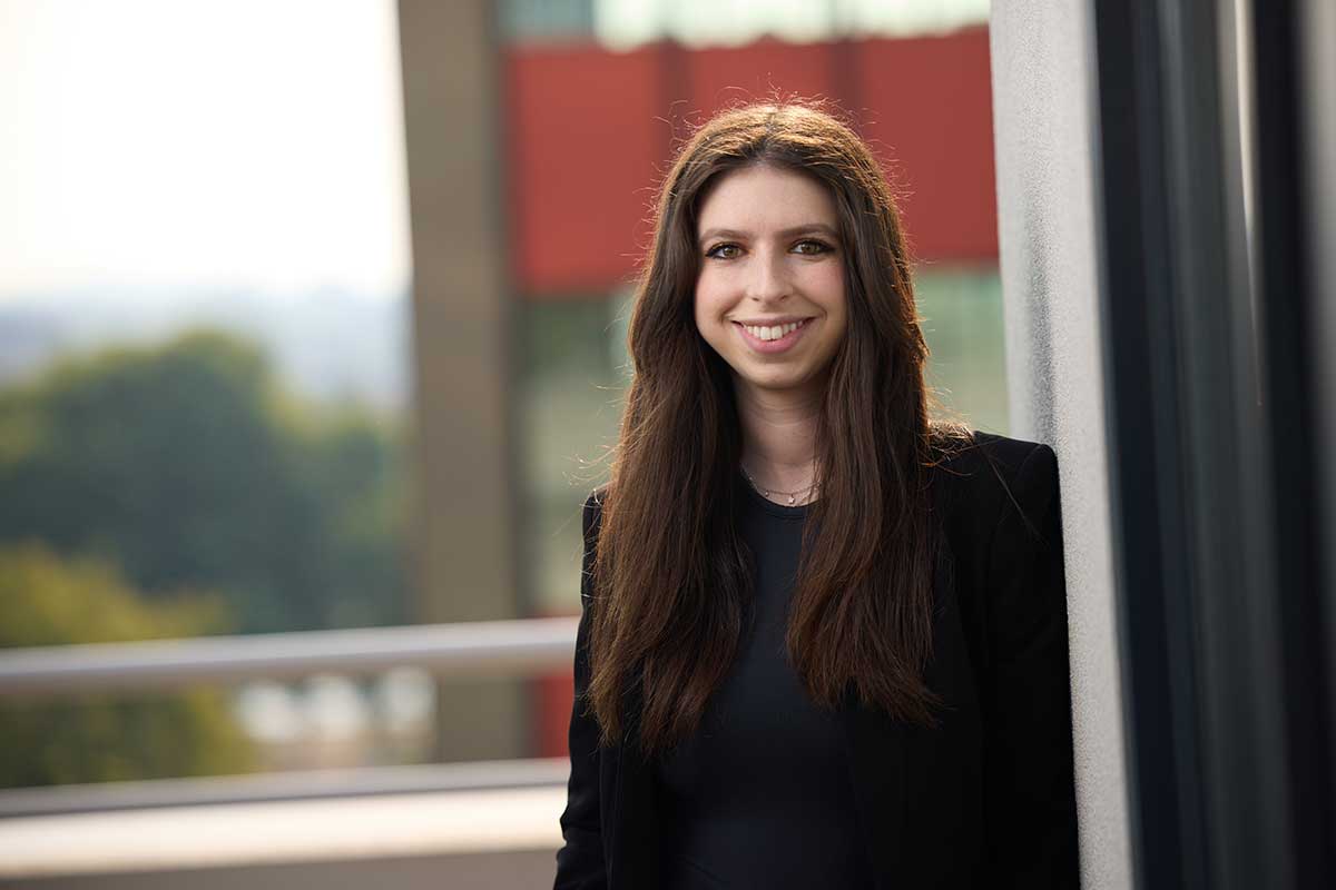 Commercial litigation and business attorney paralegal Grace Hellwarth standing outside the court house.