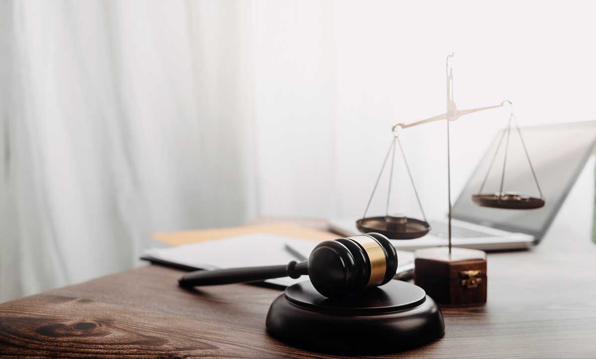 A judge’s gavel and a scale of justice on the desk of business attorney in Portland Oregon, Jeff Pitzer.